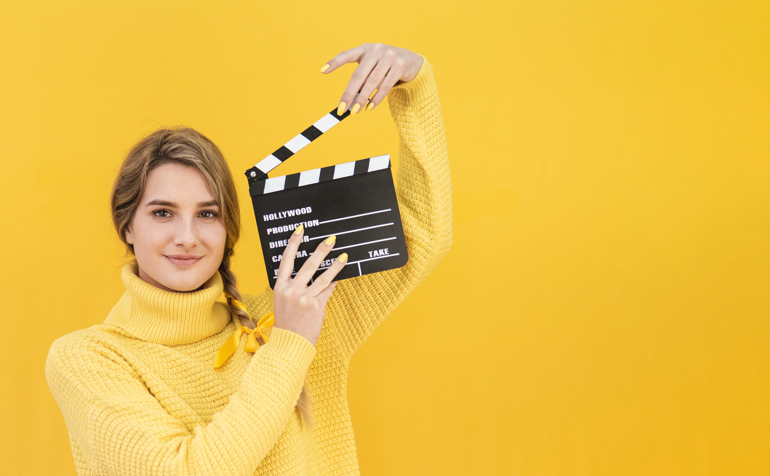 woman-holding-clapboard-with-copy-space